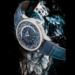PATEK PHILIPPE. A LADY’S ATTRACTIVE 18K WHITE GOLD AND DIAMOND-SET AUTOMATIC WORLD TIME WRISTWATCH