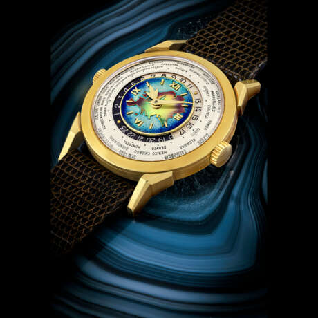 PATEK PHILIPPE. AN EXCEPTIONAL, HIGHLY IMPORTANT AND EXTREMELY RARE 18K GOLD TWO-CROWN WORLD TIME WRISTWATCH WITH 24 HOUR INDICATION AND CLOISONN&#201; ENAMEL DIAL DEPICTING THE EURASIA MAP - photo 1