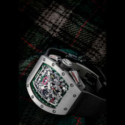RICHARD MILLE. A RARE AND ATTRACTIVE TITANIUM LIMITED EDITION TONNEAU-SHAPED AUTOMATIC SEMI-SKELETONISED FLYBACK CHRONOGRAPH WRISTWATCH WITH ANNUAL CALENDAR