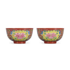 A RARE PAIR OF FAMILLE ROSE CORAL-GROUND BOWLS