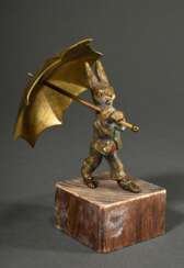 Bronze &quot;Hase mit Schirm&quot;, bekleidet mit Wams und Hose, Reste farbiger Bemalung, auf Holzsockel, H. 9,5/13cm, leicht berieben