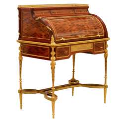 E.KAHN. Magnifique bureau cylindrique en acajou et bois satin&eacute; avec bronze dor&eacute;. 
