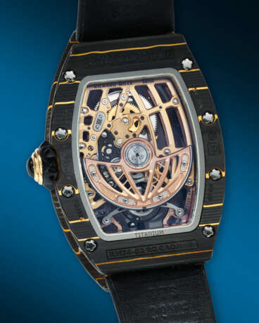 RICHARD MILLE. AN EXCEPTIONAL AND HIGHLY ATTRACTIVE GOLD CARBON TPT&#174;, 18K RED, YELLOW GOLD, AND TITANIUM ULTRA-SKELETONIZED AUTOMATIC TOURBILLON WRISTWATCH - photo 4