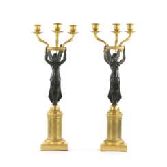 A pair of bronze candlesticks in Empire style