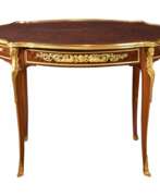 Gilded bronze. Oval coffee table in Louis XVI style, model Adam Weisweiler. France 19th century 