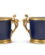 Period of Louis XV. A NEAR PAIR OF REGENCE ORMOLU-MOUNTED CHINESE POWDER-BLUE PORCELAIN CACHE POTS