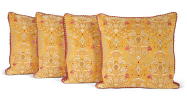 A SET OF FOUR EMBROIDERED YELLOW SILK CUSHIONS