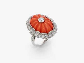 A historical ring decorated with a cut Midway coral and brilliant-cut diamonds