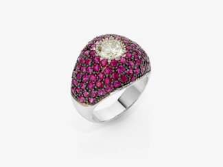 A cocktail ring decorated with rubies and a brilliant-cut diamond