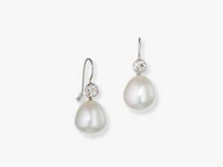 A pair of drop earrings decorated with two South Sea cultured pearl drops and brilliant-cut diamonds