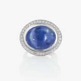 A ring with a sapphire and brilliant-cut diamonds - фото 1