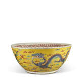 A LARGE YELLOW-GROUND FAMILLE ROSE 'DRAGON' BOWL - photo 1