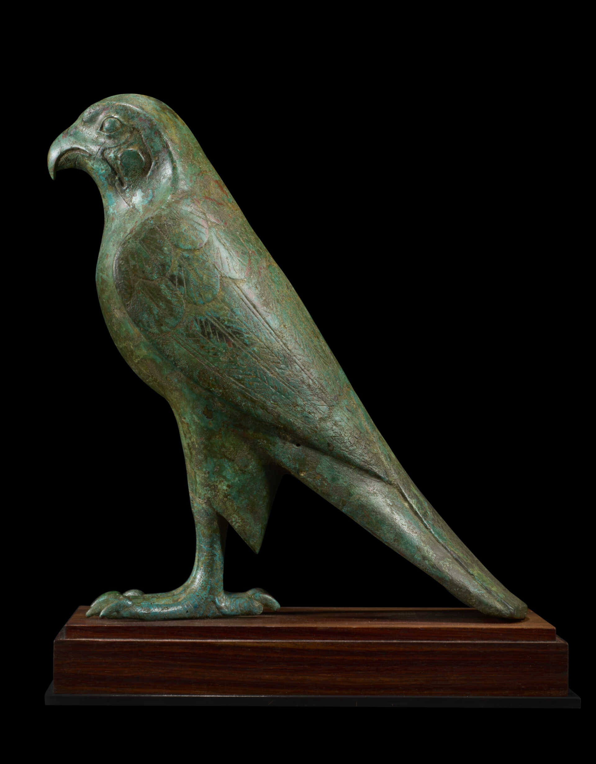 AN EGYPTIAN BRONZE FALCON