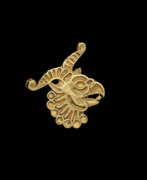 Achaemenid Empire. AN ACHAEMENID GOLD APPLIQUE OF A HORNED GRIFFIN HEAD