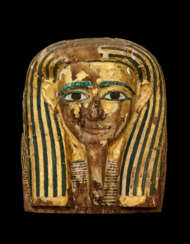AN EGYPTIAN PAINTED AND GILT WOOD MUMMY MASK