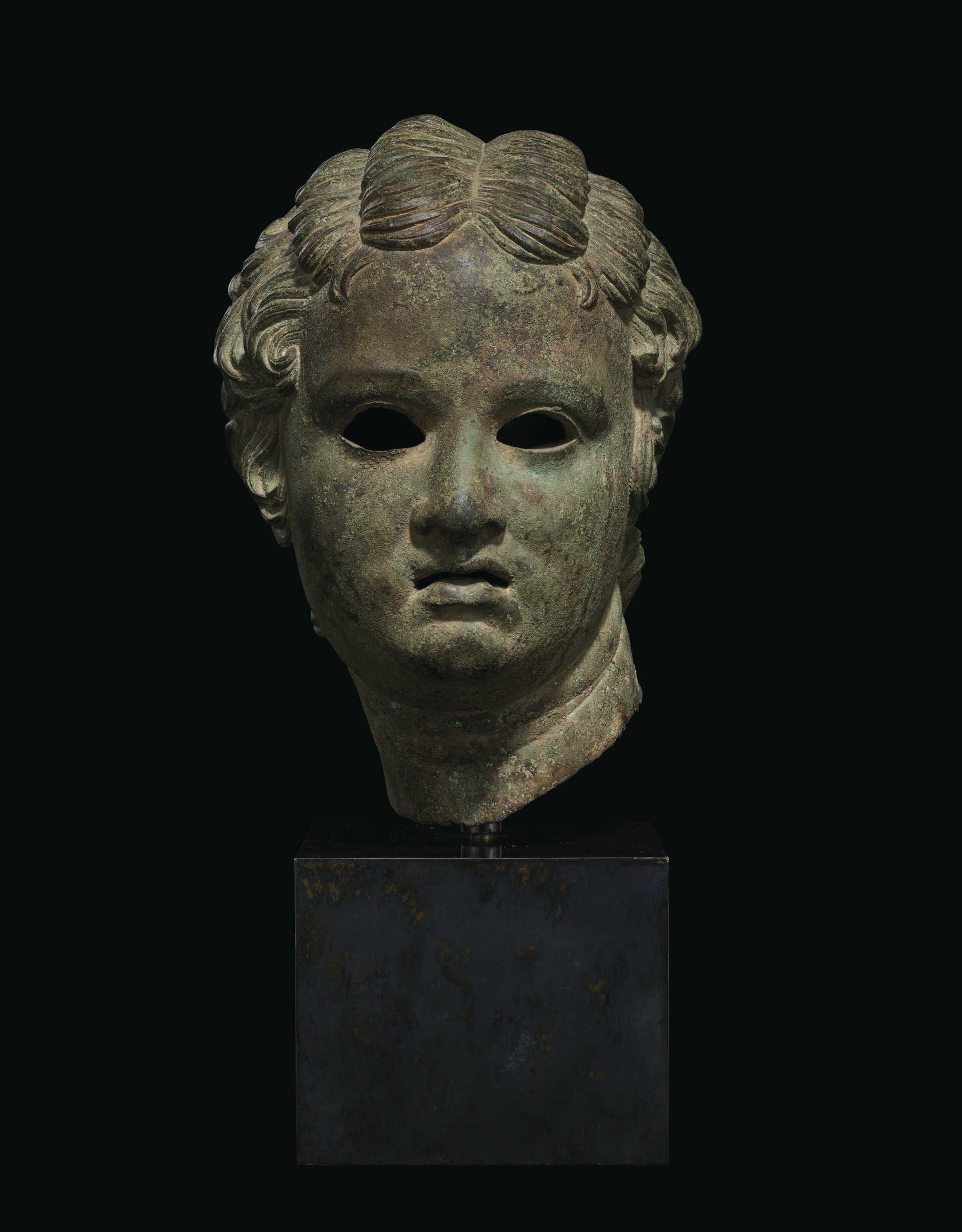 A GREEK BRONZE HEAD OF EROS