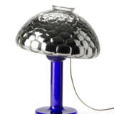 Table lamp model "Nina". Produced by Fontana Arte,, 1981. Transparent blue blown glass frame, adjustable silvered optical glass light diffuser. Bearing label. (h 50 cm.) | | Literature | G. Gramigna, Repertorio del design italiano 1950-2000 per l'a - photo 3