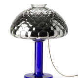 Table lamp model "Nina". Produced by Fontana Arte,, 1981. Transparent blue blown glass frame, adjustable silvered optical glass light diffuser. Bearing label. (h 50 cm.) | | Literature | G. Gramigna, Repertorio del design italiano 1950-2000 per l'a - Foto 4