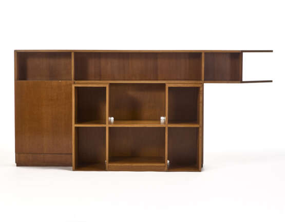 Custom-designed low cabinet, consisting of two bodies, one symmetrical central body with open compartments, the other asymmetrical with a door cupboard and three open compartments. 1960s. Solid and veneered wooden frame. (238.5x107.5x59 cm.) (defects - фото 1