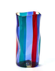 "Fasce verticali" vase model "4317". Produced by Venini, Murano, 1951ca. Transparent red, sapphire, pagliesco and green blown glass. Signed with acid "venini murano Italia". (h 22 cm.; d 10 cm.) (slight defects) | | Literature | Fulvio Bianconi all