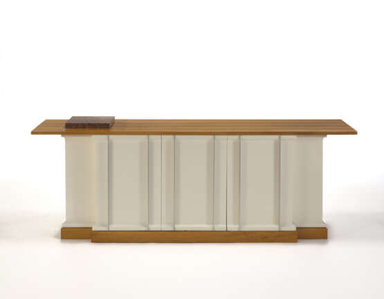 Custom-designed sideboard. How, 1970s. White lacquered wooden frame, anodised aluminium handles. Veneered light wooden base and shelf. (200x69x47 cm.) (slight defects) | | Provenance | Private collection, Como - photo 1