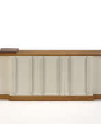 Libero Colma. Custom-designed sideboard. How, 1970s. White lacquered wooden frame, anodised aluminium handles. Veneered light wooden base and shelf. (200x69x47 cm.) (slight defects) | | Provenance | Private collection, Como