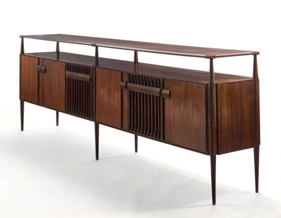 (Attributed) | Sideboard. 1960s. Six doors and six legs, double top shelf. Solid and veneered dark wood. (302.3x103x47 cm.) | | Provenance | Private collection, Cantù - фото 1