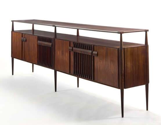 (Attributed) | Sideboard. 1960s. Six doors and six legs, double top shelf. Solid and veneered dark wood. (302.3x103x47 cm.) | | Provenance | Private collection, Cantù - photo 2