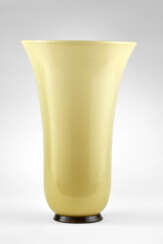 Vase of the series "Opalini". 1996. Lattimo and yellow incamiciato blown glass with applied base. Bearing label, signed with engraving under the base. (h 37 cm.; d 25 cm.)