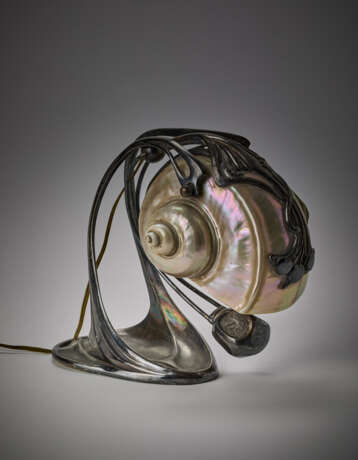 Jugendstill table lamp model "Nautilus". Austria, early 20th century. Silver-plated cast metal stem and tilting diffuser made from a nautilus. Engraved mark "MH20". (h 19.5 cm.) (defects) | | Literature | per esemplari simili: | W. Ueker, Art Nouve - Foto 1