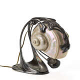 Jugendstill table lamp model "Nautilus". Austria, early 20th century. Silver-plated cast metal stem and tilting diffuser made from a nautilus. Engraved mark "MH20". (h 19.5 cm.) (defects) | | Literature | per esemplari simili: | W. Ueker, Art Nouve - photo 3
