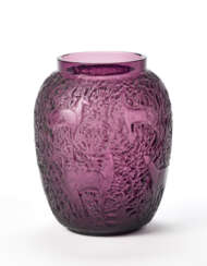 Vase model "Biches". second half 20th century. Mould-blown, bevelled and patinated transparent violet glass. Decoration with leaves and animals. Model created in 1932, revived after 1951. Signed with engraving under the base. (h 17 cm.; d 9 cm.) | 
