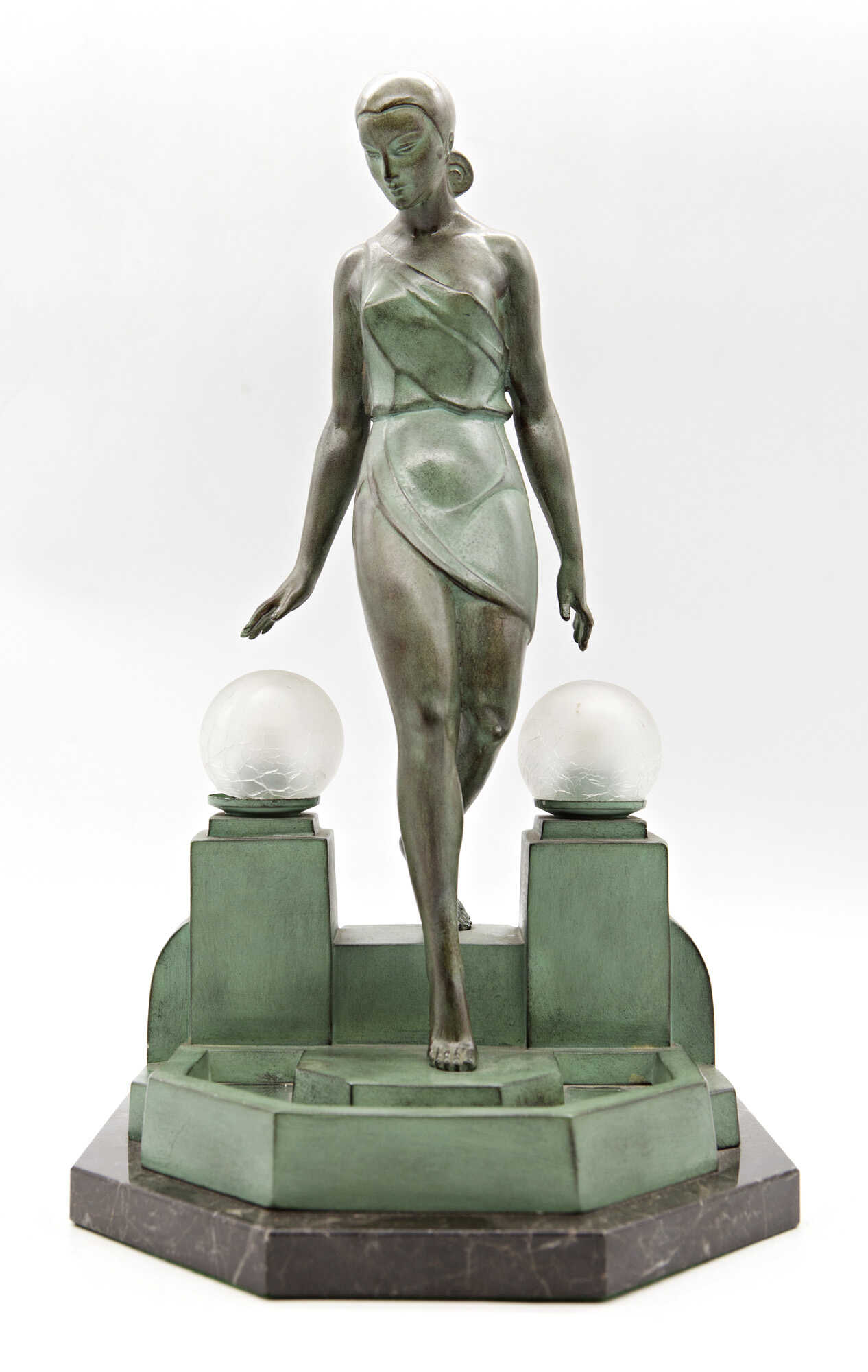 "Nausica" | Table lamp depicting maiden descending pool steps. 1930s. Artistic bronze with green patina on marble base, mirror and glass. Marked Fayral on the side and Le Verrier on the back. (26x45x25 cm.) (defects and breaks )