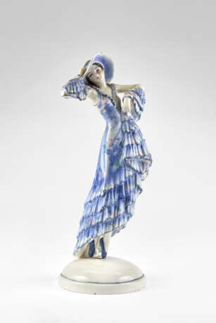 Sculpture depicting dancer model "6229". Execution by Goldscheider,, 1930s/1940s. Cast ceramic painted in light blue and polychrome under glaze. Mark of the manufacture and numerals under the base. (h max 25 cm.) (slight defects and restoration) | | - photo 1