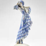 Sculpture depicting dancer model "6229". Execution by Goldscheider,, 1930s/1940s. Cast ceramic painted in light blue and polychrome under glaze. Mark of the manufacture and numerals under the base. (h max 25 cm.) (slight defects and restoration) | | - Foto 1