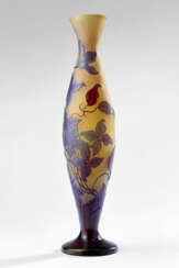 Large vase. early 20th century. Cameo-blown glass with frosted burgundy and blue floral decoration on an opalescent ground. (h max 50 cm.)