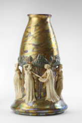 Large cast ceramic vase decorated with female figures in high relief picking fruit. Enamelled surface in a light and dark crème colour with metallic lustres on a green ochre background. Execution by Zsolnay, Hungary, early 20th century. Marked and nu