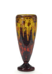 Cameo glass vase acid treated in shades of brown on a yellow-orange ground, decorated with bellflowers. 1928ca. Engraved signature "Le Verre Français" under the base. (h 44.5 cm.)