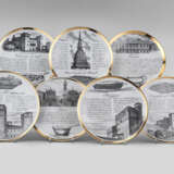 Seven plates of the series "Specialità torinesi". Milan, 1960s. Porcelain, black and gold lithographic print. Marked on verso. (d 24 cm.) (slight defects) - photo 1