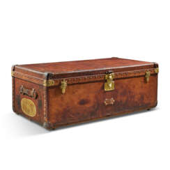 A NATURAL COWHIDE LEATHER TRUNK WITH BRASS HARDWARE