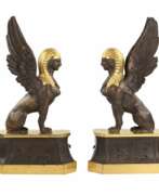 Overview. A pair of patinated and gilded bronze firewood stands in the shape of winged sphinxes. 19th century. 