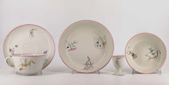 Part of a service consisting of two bowls, a cup and saucer and an egg cup in porcelain decorated with circus figures - фото 1