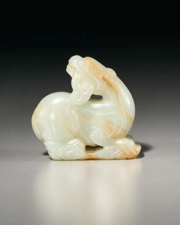 A WHITE JADE CARVING OF A RECUMBENT BEAST SUPPORTED ON VAPORS - photo 1