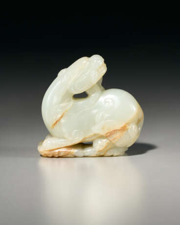 A WHITE JADE CARVING OF A RECUMBENT BEAST SUPPORTED ON VAPORS - photo 2