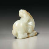 A WHITE JADE CARVING OF A RECUMBENT BEAST SUPPORTED ON VAPORS - photo 3