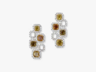 A pair of expressive drop earrings decorated with natural, multi-coloured fancy yellow diamonds and white brilliant-cut diamonds