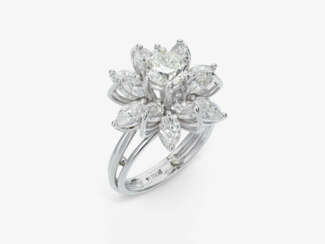 A stylized floral cocktail ring decorated with a brilliant-cut diamond and navette-cut diamonds