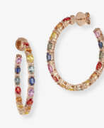 Bijoux d'oreille. A pair of hoop earrings decorated with multi-coloured sapphires and brilliant-cut diamonds