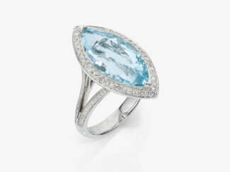 A modern marquise ring decorated with a bright light blue aquamarine and brilliant-cut diamonds