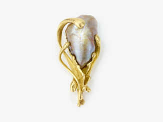 A brooch with a large baroque cultured pearl